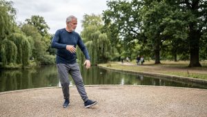 An older man performing gentle tai chi in a tranquil park, a perfect outdoor activity to relieve stress